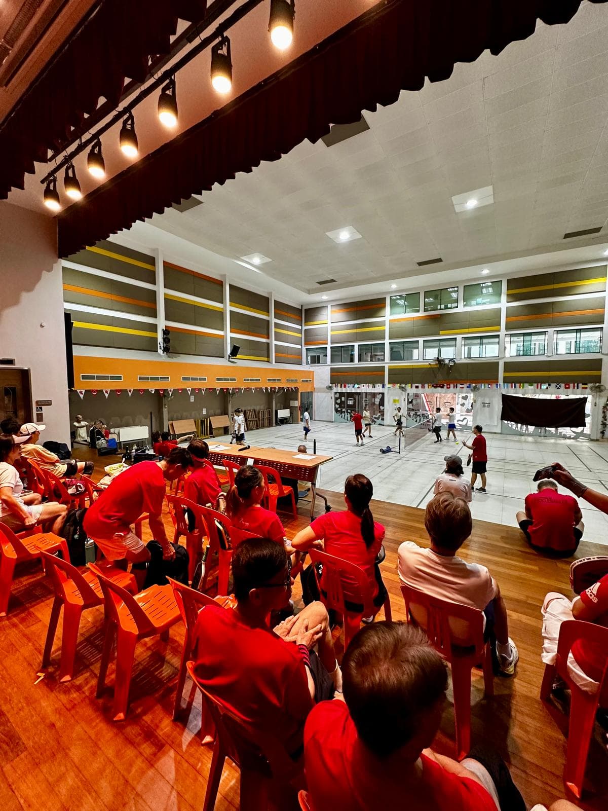 Spectators watch two courts of play from courtside seating during a Season 1 session.